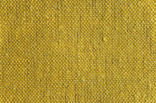 Texture of rustic linen fabric of yellow color.