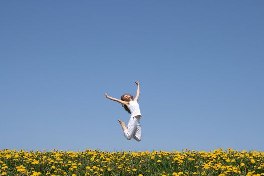 Beautiful smiling young woman in a happy jump.