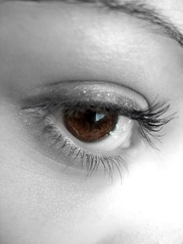 A macro shot of a pretty womans eye with selective color.