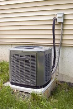 A residential central air conditioning unit sitting outside a home.