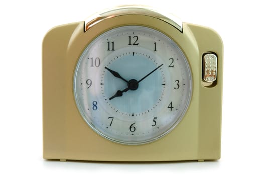 Alarm clock (with gold plastic body) on overwhite background.