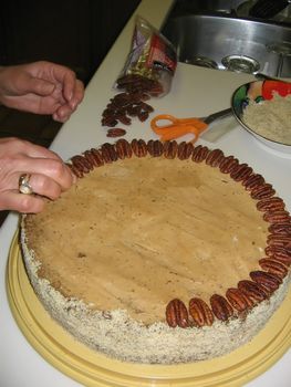 A layered walnut cake filled with walnut paste, orange jam and finished with buttercream, almonds and raspberrie