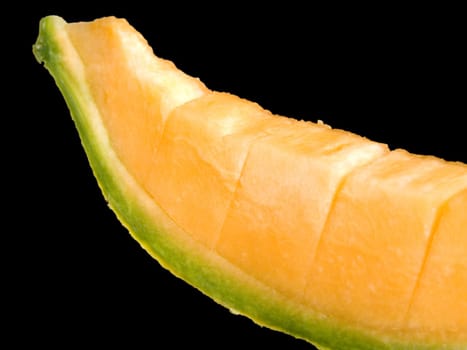 Close-up of a slice of ripe melon isolated on black