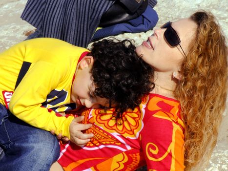 Mother and child relaxing on the beach