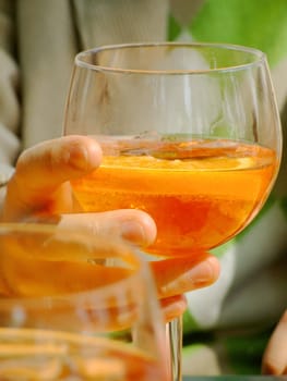 Hand holding a long drink glass during happy hour