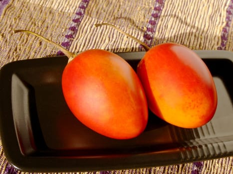 Close-up of two ripe tamarillos