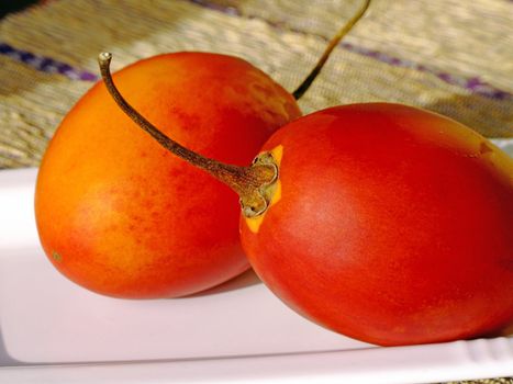 Close-up of two ripe tamarillos
