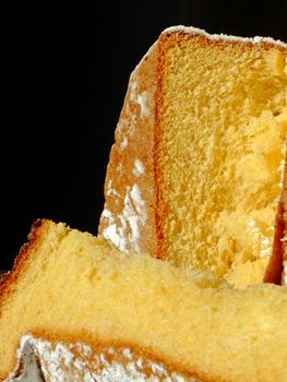 Pandoro, traditional italian Christmas cake isolated on black. It is also well known as golden cake of Verona