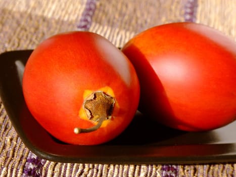 Close-up of two ripe tamarillos