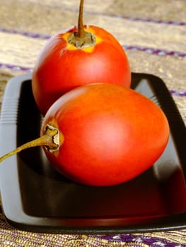 Close-up of two ripe tamarillos
