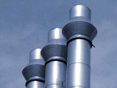 Three industrial pipes, blue toned