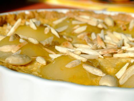 Close-up of a homemade tart Bourdaloue with pears, almond cream and vanilla custard