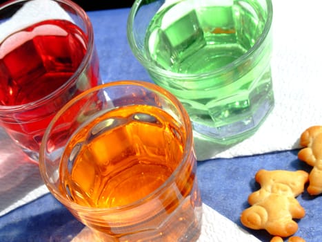 Close-up of three mini drinks and some snacks