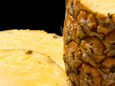 Close-up of half and two slice of pineapple