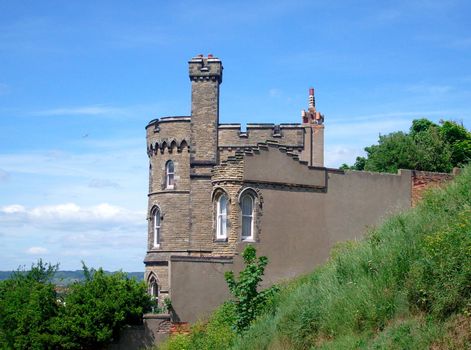 Historic house shaped like a castle with battlements and turrets.