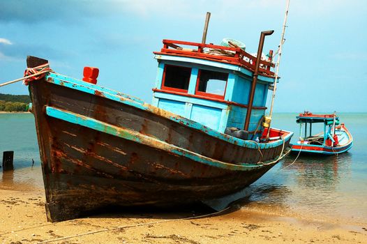 Fishermans boats on the ocean coast. Sun sand and sea.