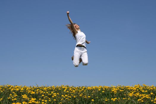 I love life! Smiling girl in a happy jump.