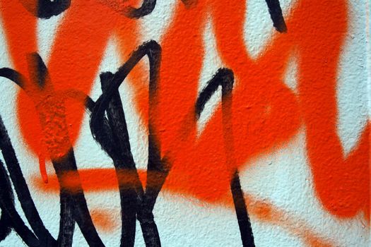 Abstract airbrush graffiti detail on a metallic surface.