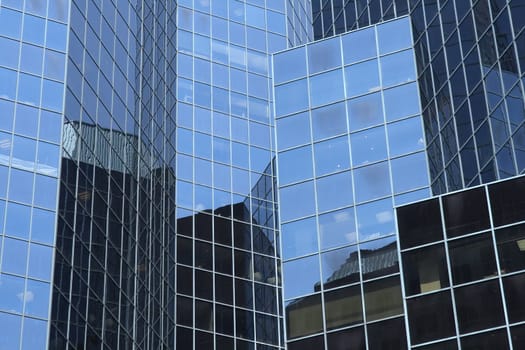 Reflections in a modern glass-windowed office building.