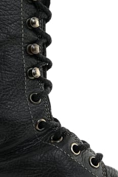 Closeup of black leather boot, showing laces in detail.