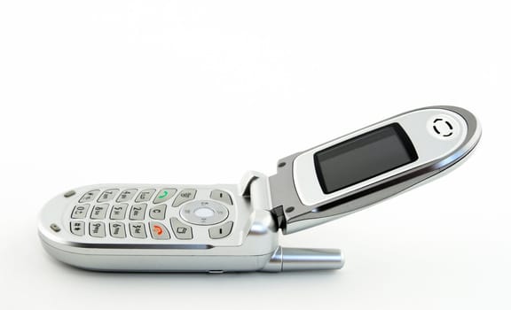 Open silver clamshell cell phone, over white background.