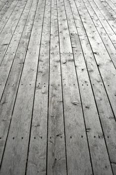Nailed wooden flooring. Gray knotty wooden planks.