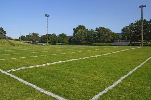 American football playing field under blue sky.