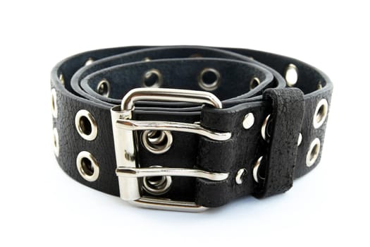 Black studded leather belt with metal buckle, on white background, shallow DOF.