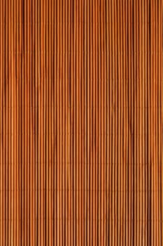 Oriental rattan mat texture of warm orange color.