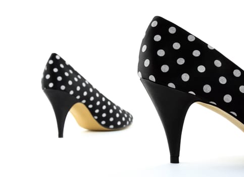 Black polka high heel shoes. Focus on the closest shoe.