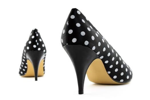 Black retro high heel polka shoes. Focus on the closest shoe.