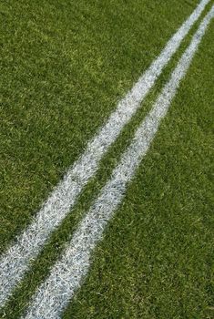Boundary lines of a green playing field, diagonal.