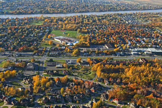 Aerial view of a suburban neighborhood in bright colors of autumn.
