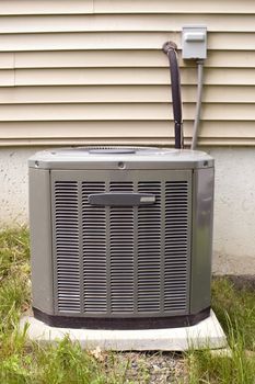 A residential central air conditioning unit sitting outside.
