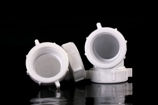 Two angular connectors from white plastic, are used in the water industry.