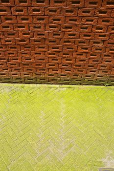 Brick wall and green pavement. Amsterdam.