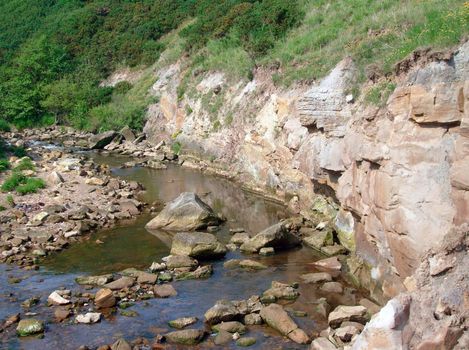 River running through gorge in countryside.