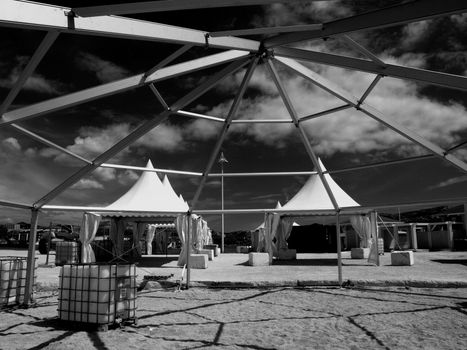 shadows playing of a structure and grids on a beach