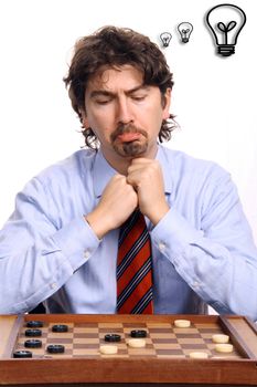 businessman playing chess over white background