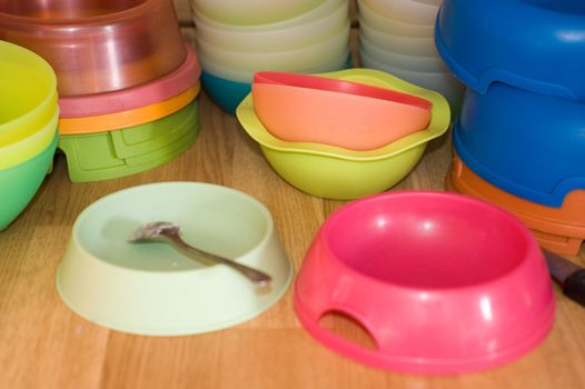 Colorful pet bowls piled up with shallow depth of field