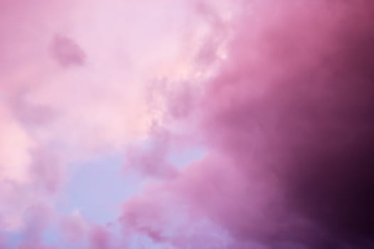 Dramatic pink clouds at sunset with soft focus for dreamy look