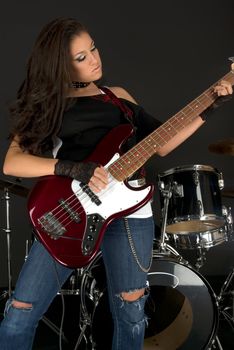 Rock star with beautiful make up playing guitar