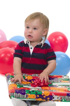 Very cute baby boy opening his birthday gift
