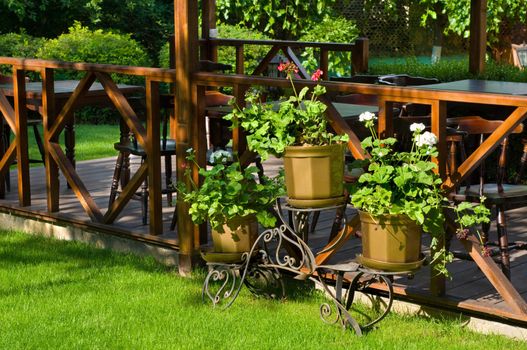 empty well decorated open air cafe with lots of green plants