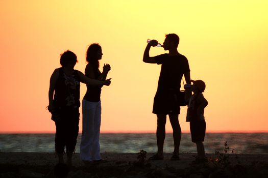 Family with child on sundown background 2