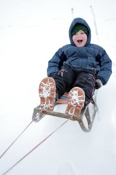 Winter riding of the boy on sled 2