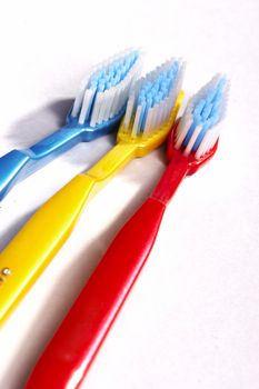 three  variegated tooth-brushes