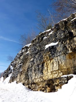 Cliff covered by snow by beautiful winter weather