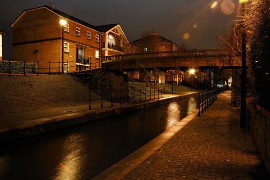 night street in Cardiff with brook, house, and bridge