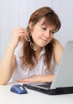 Young woman reading from screen of laptop